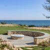 outdoor patio with firepit and ocean in the back