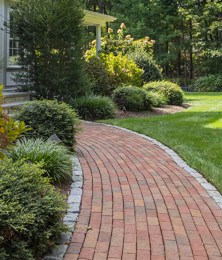 Red brick paver walkway with cobblestone border