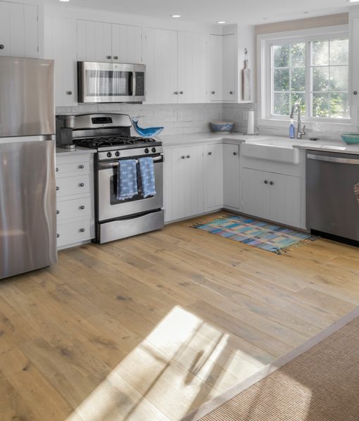 a large kitchen with a light brown floor