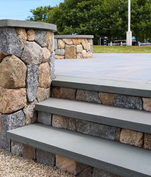 natural stone steps to patio with fire pit