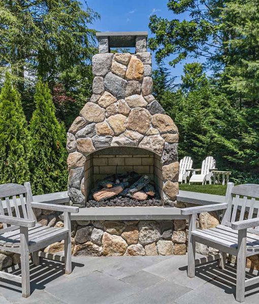Natural stone fireplace on patio backyard