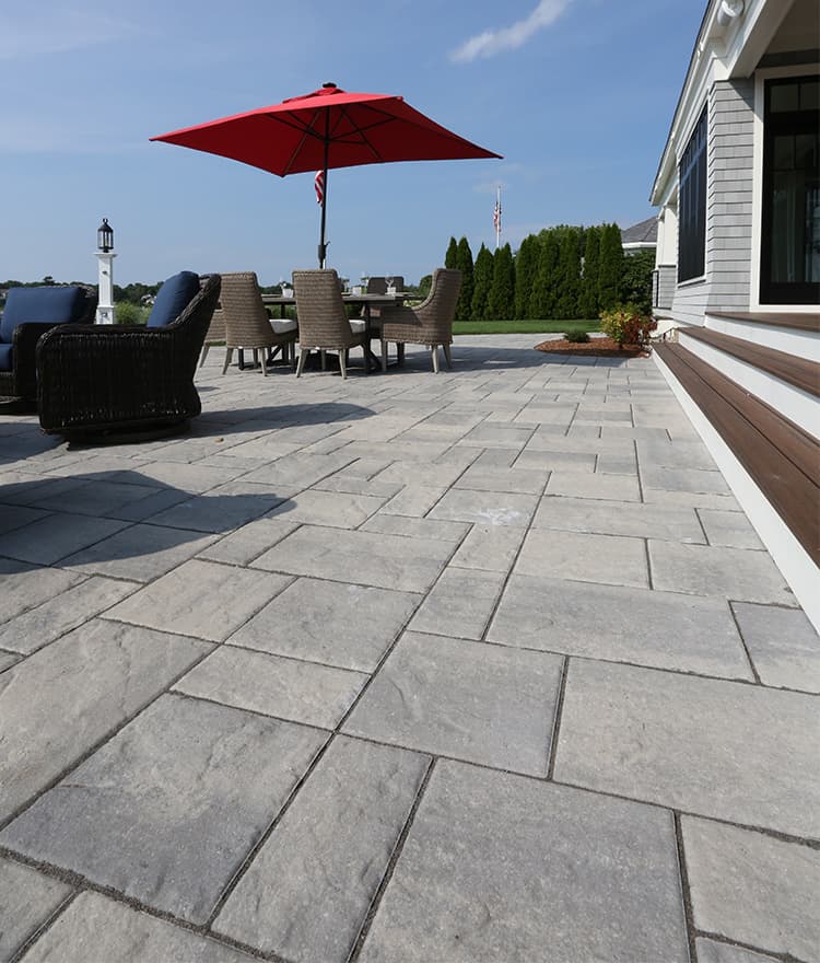 Waterfront Patio featuring Techo Bloc Blu60 Slate Grey Pavers, Ebel Furniture and Custom Fire Pit