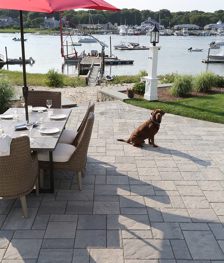 Waterfront Patio featuring Techo Bloc Blu60 Slate Grey Pavers, Ebel Furniture and Custom Fire Pit