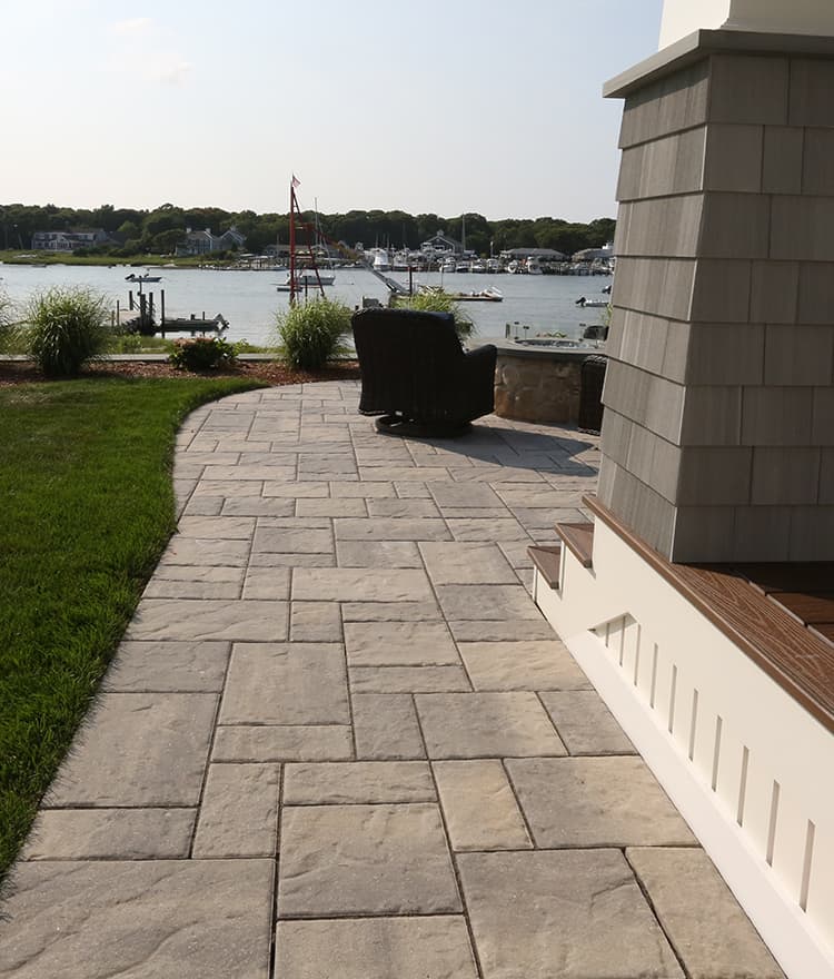 Waterfront Patio featuring Techo Bloc Blu60 Slate Grey Pavers, Ebel Furniture and Custom Fire Pit