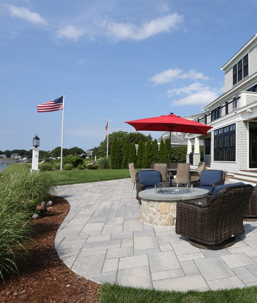 Waterfront Patio featuring Techo Bloc Blu60 Slate Grey Pavers, Ebel Furniture and Custom Fire Pit