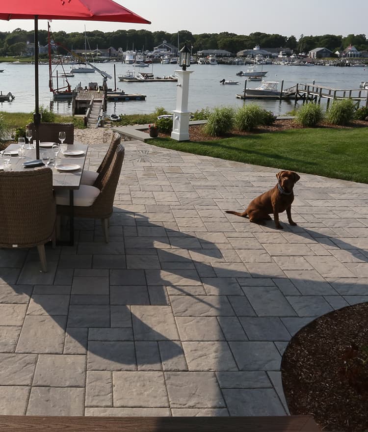 Waterfront Patio featuring Techo Bloc Blu60 Slate Grey Pavers, Ebel Furniture and Custom Fire Pit