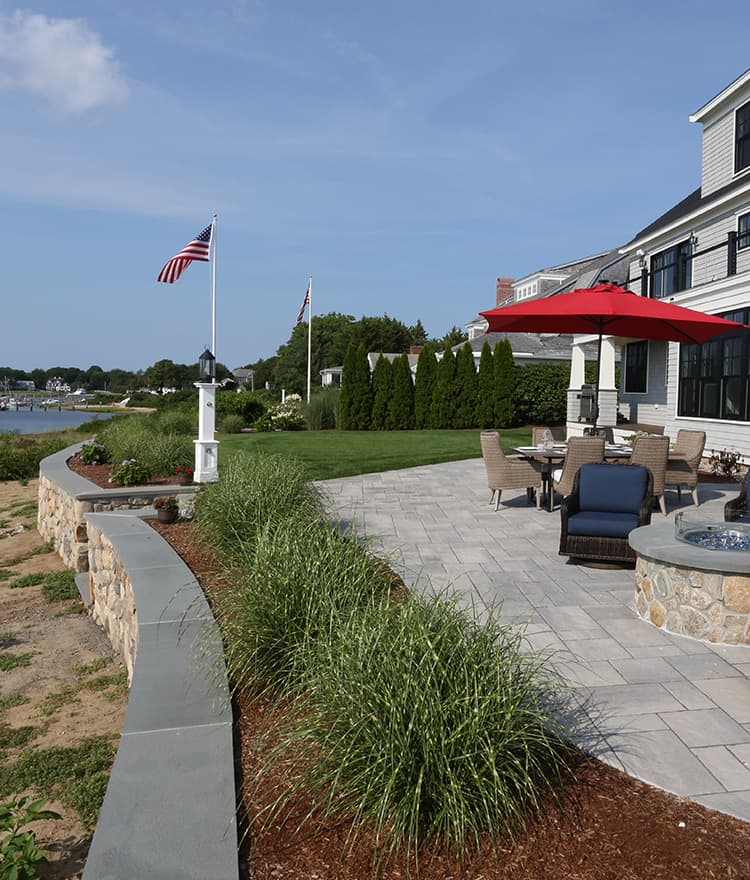 Waterfront Patio featuring Techo Bloc Blu60 Slate Grey Pavers, Ebel Furniture and Custom Fire Pit