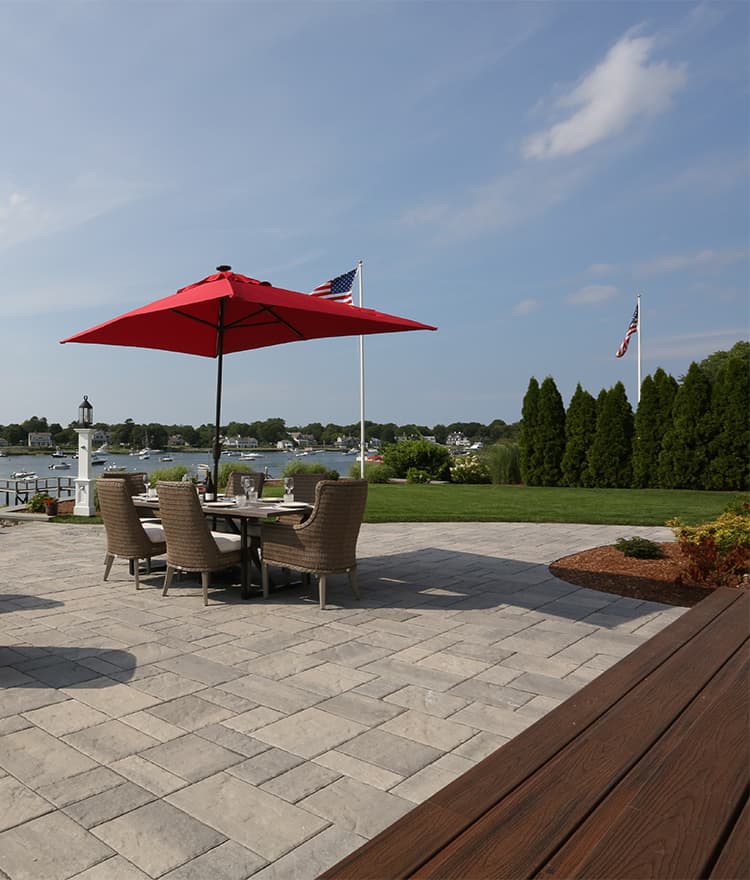 Waterfront Patio featuring Techo Bloc Blu60 Slate Grey Pavers, Ebel Furniture and Custom Fire Pit