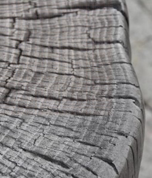 up close detail of classic gray tree stump fire pit