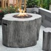 gray tree stump gas fire pit on patio