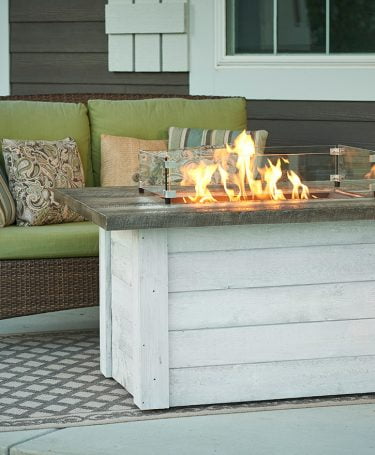 lit coastal style fire table