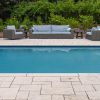 outdoor marble paver poolside with chairs