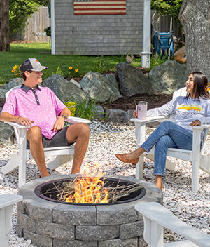 couple sitting by a stone-fire pit