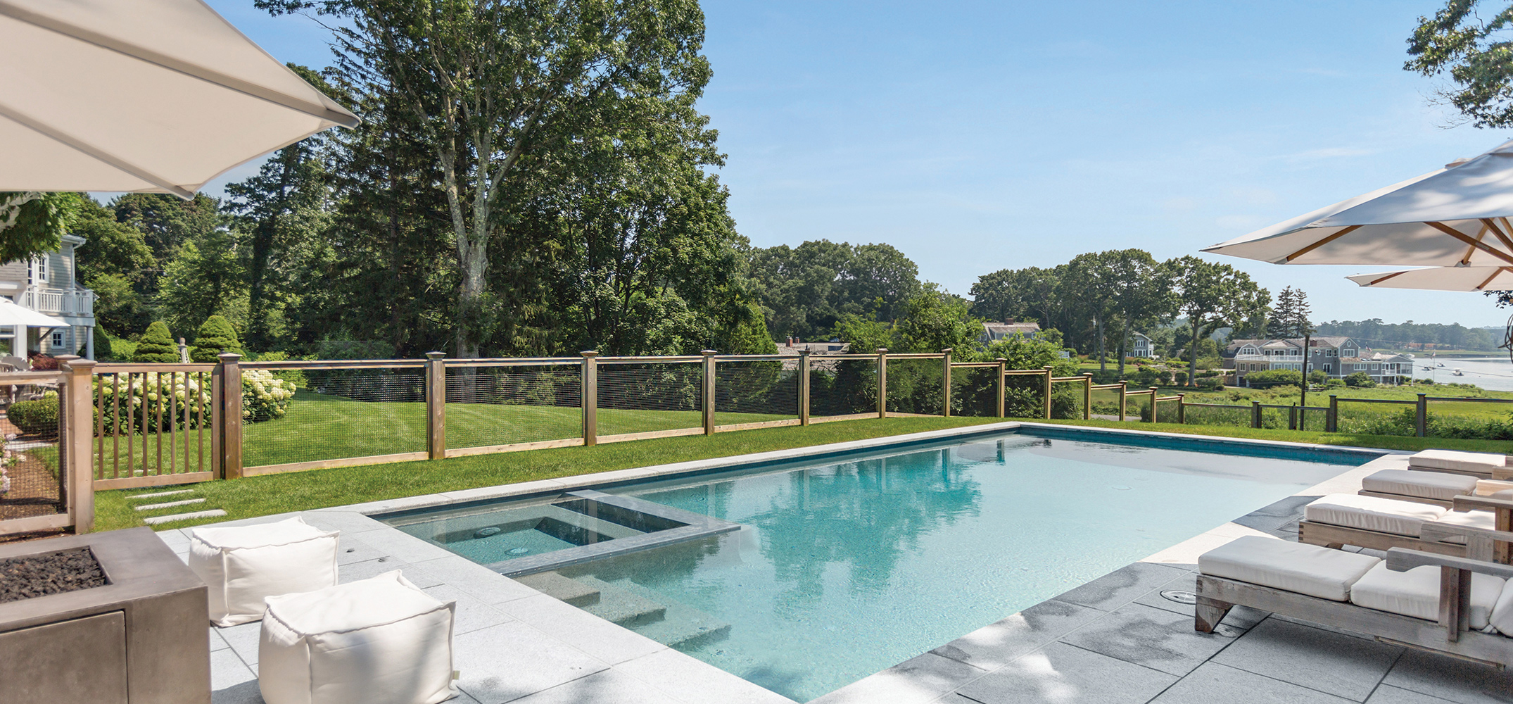 cedar fencing shown around a pool with a harbor view