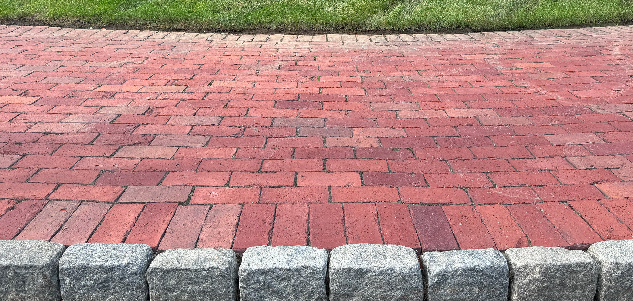 brick walkway shown with cobblestones as edging close up