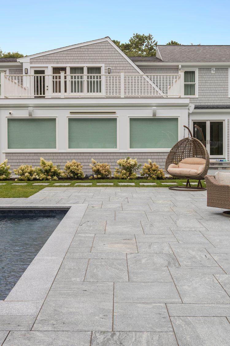 Silver granite flagging laid in pattern around backyard pool