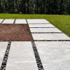 Beautiful backyard garden with silver granite steppers and black beach pebbles