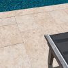 Pool patio with natural warm beige limestone pavers and coping