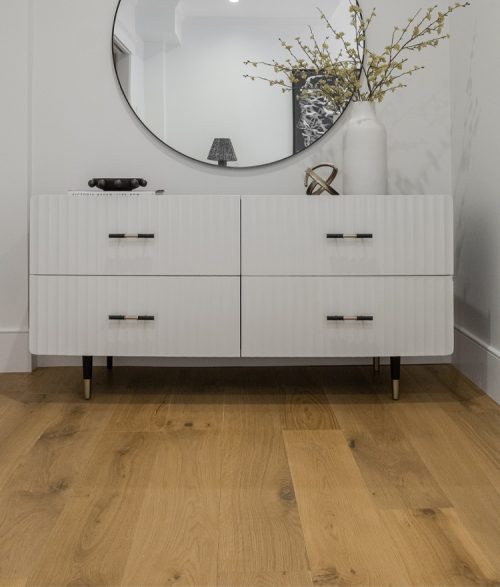 brown toned natural wood floor shown with circular mirror in boston