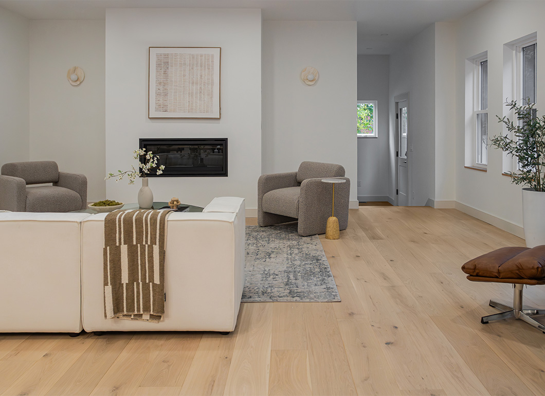 Living room with light wide plank flooring