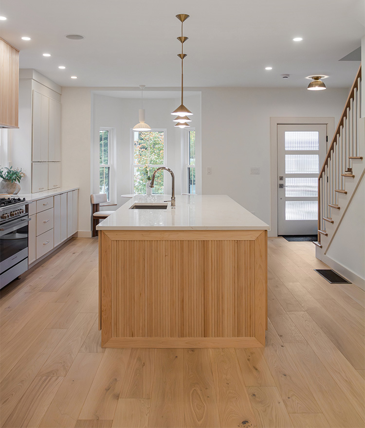 Side view of kitchen with island and natural engineered oak flooring