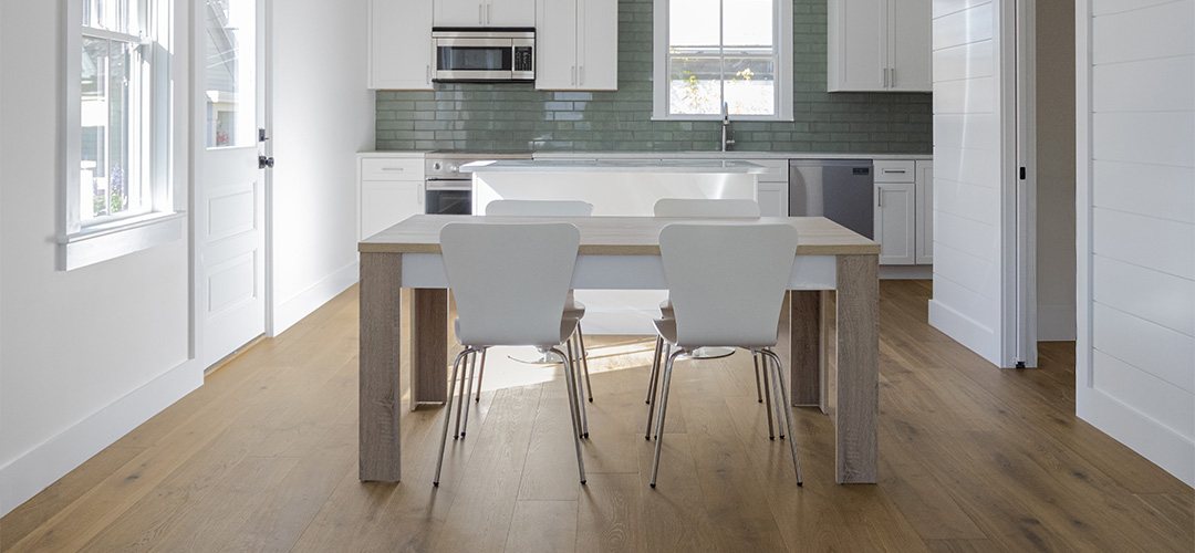 Neutral apartment kitchen with brown European French Oak wide plank flooring