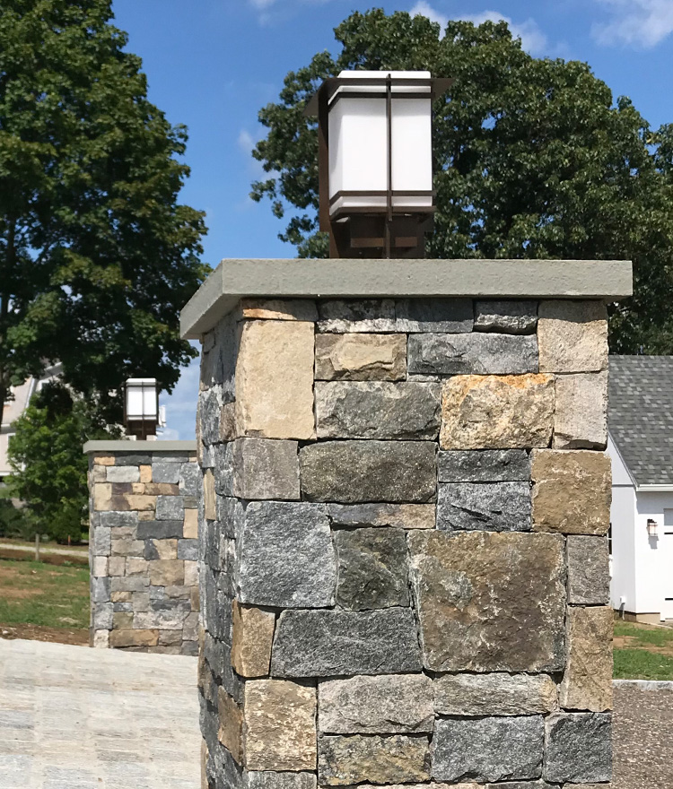 Natural ashlar thin stone veneer stone light post on a driveway