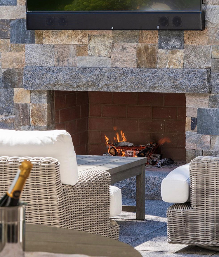 Natural stone square and rec thin stone veneer lit fireplace
