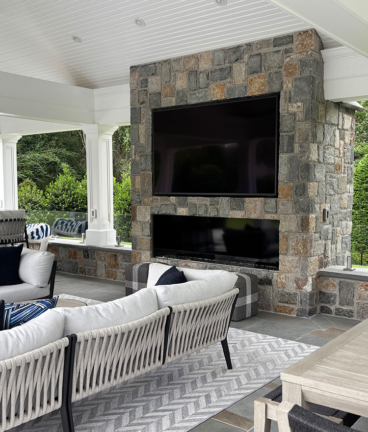 Square and rec thin stone veneer gas fireplace and wall on an outdoor patio