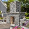 Backyard fireplace with gray ledgestone veneer and corner pieces