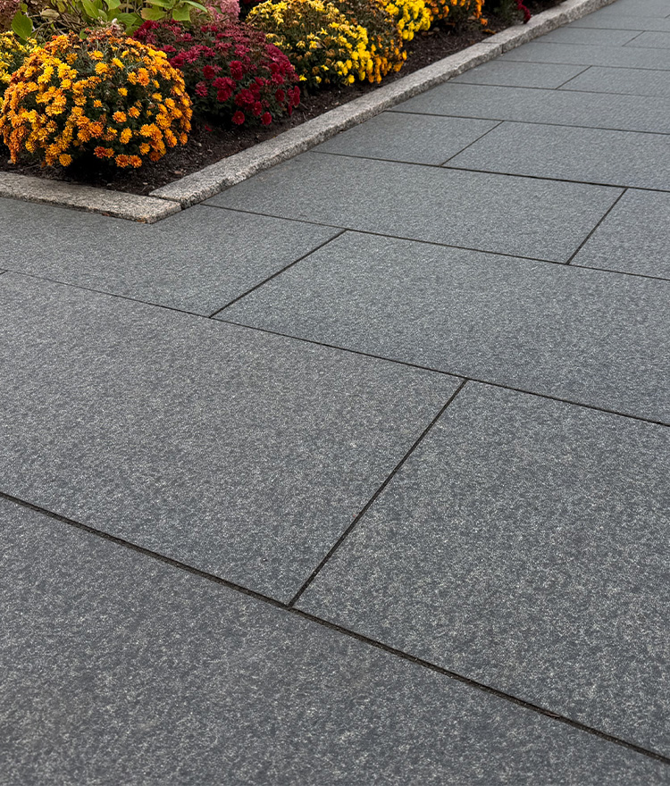 Shot of dark gray granite stone entrance shown