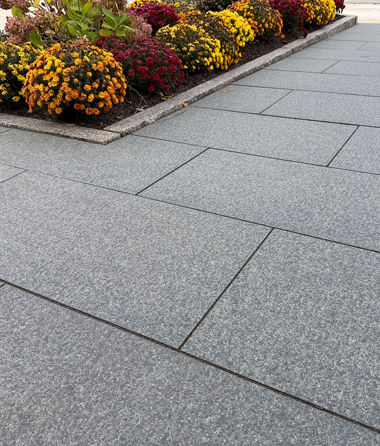 Shot of dark gray granite stone entrance shown