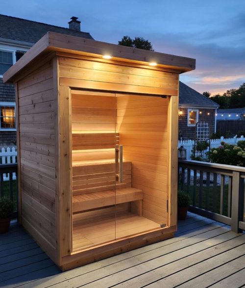 outdoor sauna shown on back deck of home at dusk