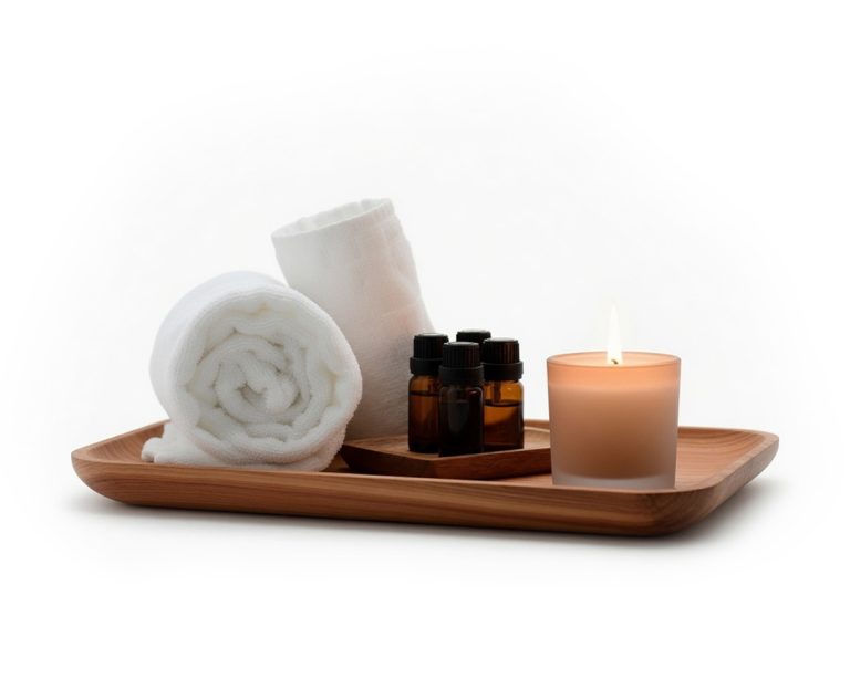 towels, oils, and a candle on a cedar tray